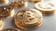 © andi - Close-up gold Bitcoin coins on light surface, many in background.  Use Cryptocurrency concept