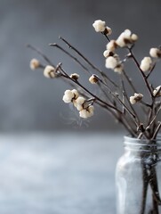 Poster - Elegant floral arrangement in a glass jar featuring delicate branches and soft white blooms : Generative AI