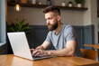 © Rick Captura - Man Working on Laptop at Table in a Casual Setting