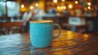 © sidiqrrt - A teal ceramic mug filled with a warm beverage is depicted