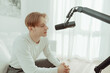 © Shotmedia - Podcaster man talks into a microphone in front of his mouth, speaking and recording his voice to upload and publish his thoughts and opinions on a topic to a streaming service - podcast record