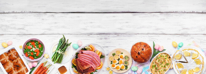 Aufkleber - Classic Easter ham dinner. Top view bottom border on a white wood banner background with copy space. Ham, scalloped potatoes, vegetable side dishes, eggs, breads and lemon cake dessert.