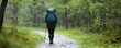 © Влада Яковенко - Female hiking in rainy forest with backpack on trail