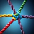 © Yiannos - Multicolored Rope knot on blue background. Vector illustration.