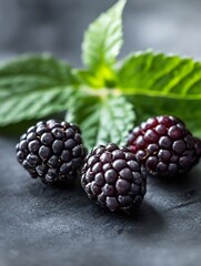 Poster - Fresh ripe blackberries arranged beautifully with green mint leaves on a dark surface : Generative AI
