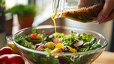 Woman pouring dressing on a mixed salad