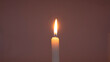 © hayyolapack - A candle burning on a dim background