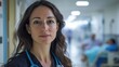 © Daiki - A confident European woman wearing a stethoscope stands in a hospital corridor. This portrait showcases her dedication to healthcare and patient well-being in a professional environment.