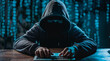 © Domingo - Mysterious hacker anonymous figure in hooded sweatshirt typing on keyboard against blue matrix background, representing cyber crime and digital threats in contemporary hacking scenario