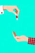 © Rysak - hand offering a red and white capsule to another hand