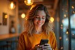 © Premium Illustration - Young smiling woman with wavy hair wearing orange sweater looking at smartphone texting in cozy cafe evening warm lighting ideal for lifestyle, communication, technology, social media background scen