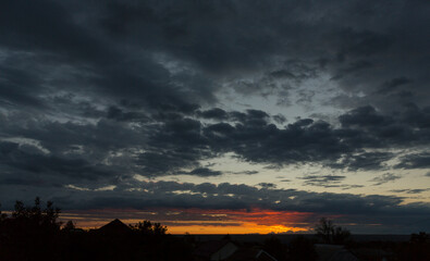 Wall Mural - Landscape at sunset. Tragic gloomy sky. Panorama. Crimson twilight.