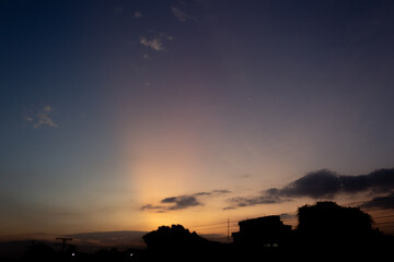 Wall Mural - beautiful sunset over the city. silhouette of a building.