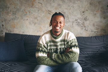 Fototapete - Man, happy and portrait with arms crossed on sofa for weekend break, relaxing and confidence. Space, African person and comfortable with smile on couch for resting, day off and peaceful in apartment