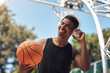 © peopleimages.com - Basketball, man or headphones with ball outdoor for match practice, training podcast or fitness break. African person, athlete or listening to audio for game performance or exercise playlist on court