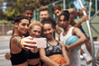 © peopleimages.com - Sports, basketball and selfie of friends on court for match, practice and competition outdoors. Fitness, team and happy men and women with picture for social media after training, game and exercise