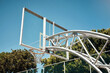 © peopleimages.com - Basketball, sports and hoop on empty court in outdoors park for match, competition and game. Blue sky, background and back board with net for goals in training, practice and exercise for fitness