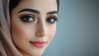 © watcharee - A close-up portrait of a woman with striking features, wearing a headscarf, showcasing elegance and beauty with captivating eyes and soft makeup.