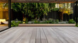 © JuanM - Modern outdoor space with wooden deck and lush landscaping in evening light