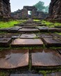 © InkCrafts - Ancient stone pathway leading to an archway in a moss-covered temple.
