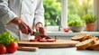 © wichit - Culinary Artist Precisely Slicing Fresh Tomatoes on Wooden Board in Sunny Kitchen