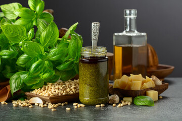 Poster - Pesto sauce and ingredients on a black stone table.