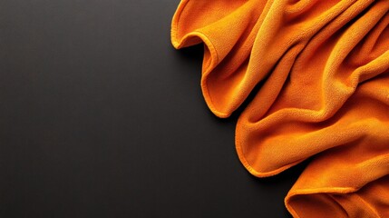 Poster - Soft Orange Fabric on Dark Background for Textures and Patterns