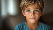 © Nataliia_Trushchenko - Young boy with blue eyes and a blue shirt is smiling. He has a light brown hair and a light skin