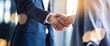 © Tonay - Professional Business People Handshake Agreement Corporate Deal Teamwork Success Partnership Collaboration Closeup Image Strong Reliable Trustworthy Dealmaking Modern Office Blue Suits Goal Sales