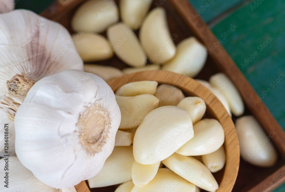 Peeled garlic in wooden bowl Stock Photo | Adobe Stock