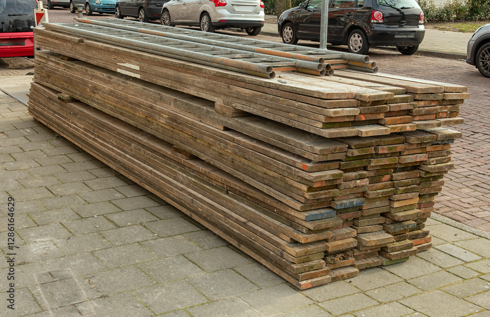 wooden construction scaffolding planks are stacked on top of each other