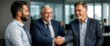 © Pathi - Blurred background capturing a side view of professionals shaking hands, indicating business success