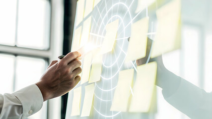 Wall Mural - Futuristic Macro Shot of Hands Placing Virtual Sticky Notes on a Holographic Board: A Close-Up of Teamwork and Idea Generation in a Business Meeting with Glowing Light and Copy Space