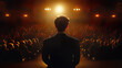 © remake - Professional speaker silhouette on stage faces large audience in dark theater hall. Spotlight illuminates performer during conference presentation. Elegant suited figure addresses crowd in formal