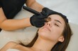 © Serhii - hands of the master who performs the procedure of permanent makeup of eyebrows. Permanent eyebrow makeup PMU for brunettes