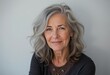 © ILIUSIA - Older Woman with Gray Hair and a Cardigan Smiling for a Portrait