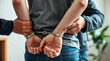 © redtiger9 - Police Officer Arresting Criminal Suspect Restraining Hands with Handcuffs for Detention and Investigation
