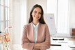 © fizkes - Businesswoman in elegant jacket pose in creative workspace. Portrait of manager, department head, smile, feel satisfied with successful project completion, promotion, recognition in professional field