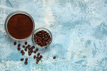 Wall Mural - Bowls of coffee powder and beans on blue grunge background