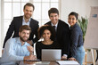© fizkes - Group of millennial multinational teammates posing for camera in modern conference room. Portrait of five successful, motivated, skilled staff members working on joint online project in company office