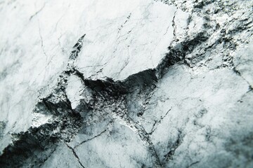 Aufkleber - Close-up of a fractured, grey stone surface revealing intricate textures and cracks.