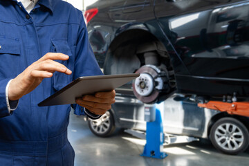 Poster - Serviceman with tablet checks car software in car service