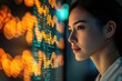 © Canvas - A young woman intently studies a screen filled with complex data and code, illuminated by warm and cool light.