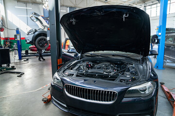 Poster - Car service workshop with cars on a column lifts