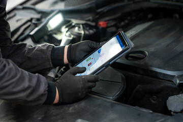 Poster - Serviceman with tablet checks car software in car service