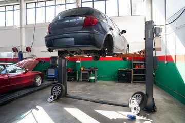 Poster - Car service workshop with cars on a column lifts