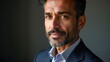 © Ada - Headshot close up portrait of indian or latin confident mature good looking middle age leader, ceo male businessman