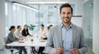 © Firman Dasmir - Smiling businessman leading a meeting in modern office with confidence