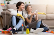 © Prostock-studio - Smiling young couple relaxing with smartphone after spring-clean apartment, sitting on floor with lots of detergents and cleaning supplies, free space