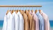© Bella - Linen shirts hanging beach clothing rail summer